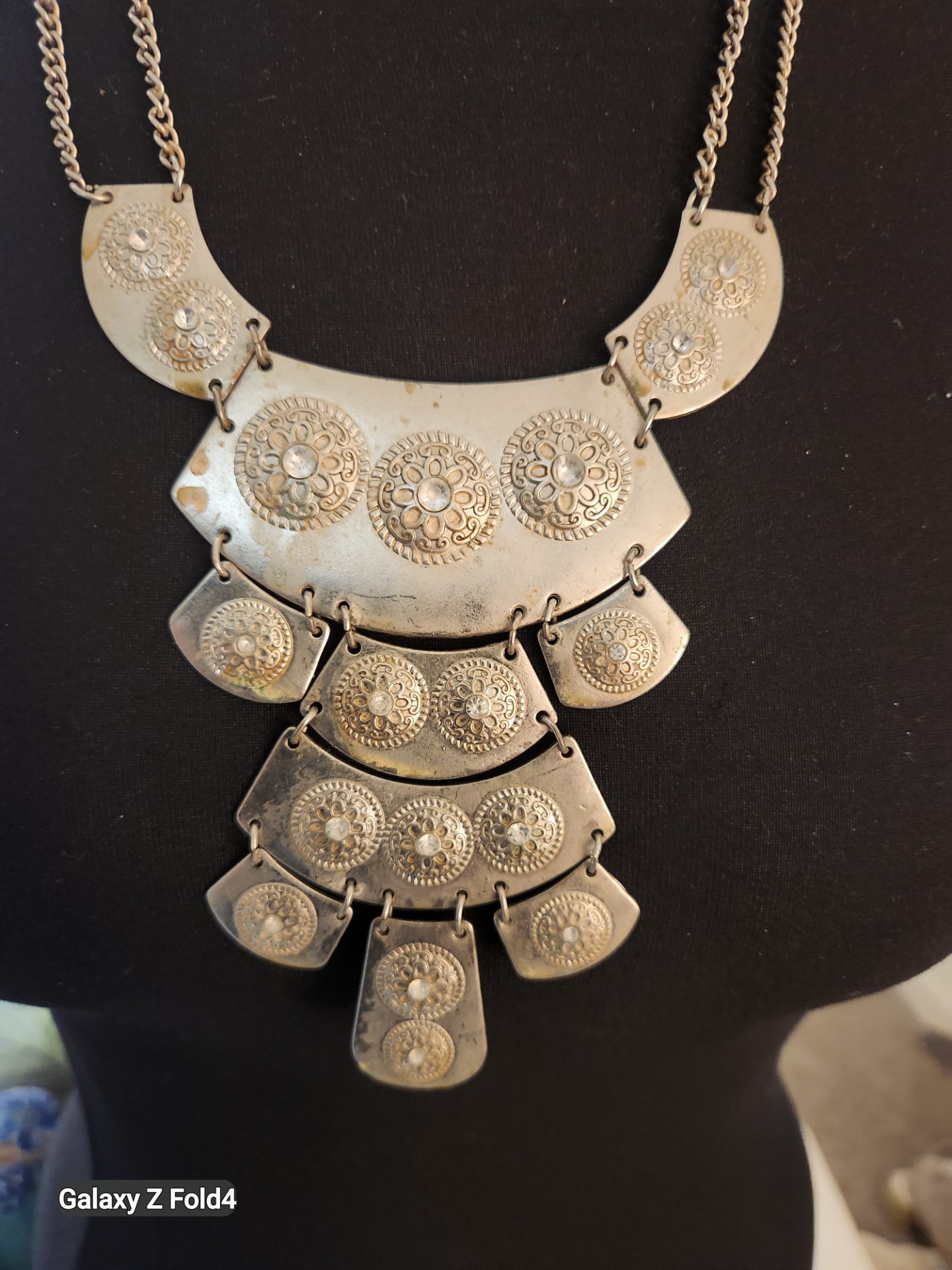 Silver-tone bohemian bib statement necklace featuring a multi-tiered, architectural fringe!